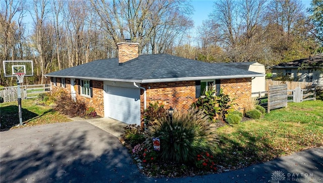 view of home's exterior with a lawn and a garage