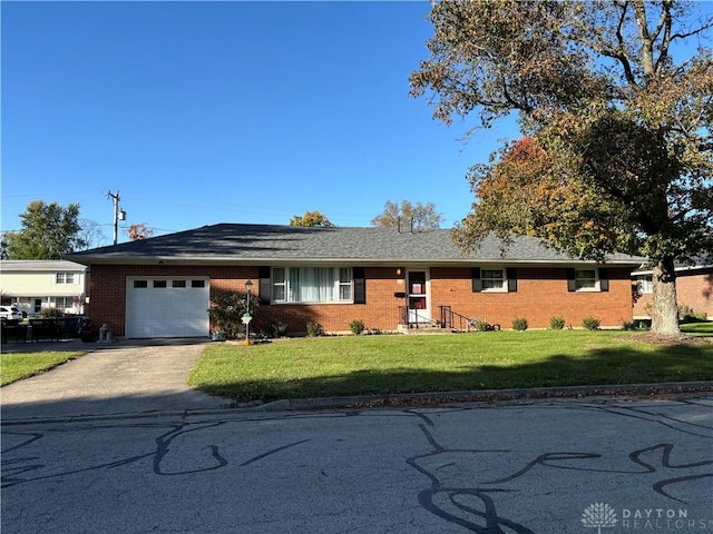 ranch-style home with a front lawn and a garage