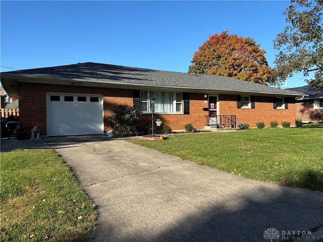 single story home with a garage and a front lawn