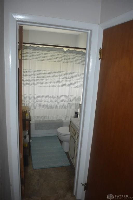 bathroom featuring vanity, tile patterned flooring, a shower with curtain, and toilet