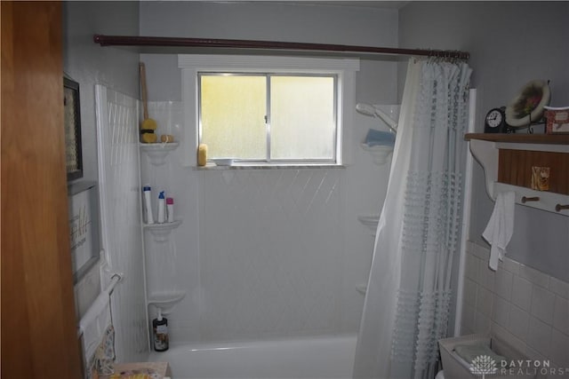 bathroom with shower / bath combo with shower curtain