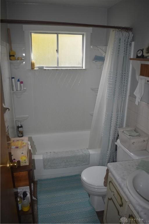 full bathroom featuring vanity, shower / tub combo with curtain, and toilet