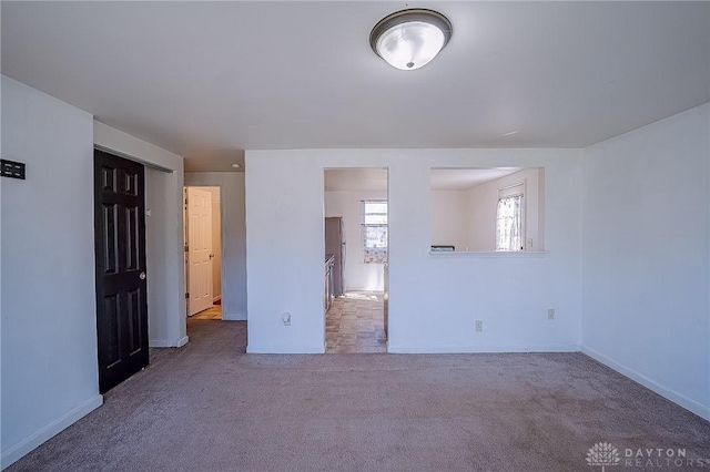 unfurnished bedroom featuring a closet and carpet floors