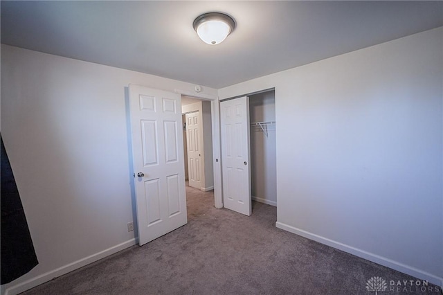 unfurnished bedroom featuring carpet and a closet