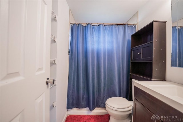 full bathroom with shower / tub combo with curtain, vanity, and toilet