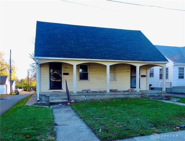 bungalow-style home featuring a porch and a front yard