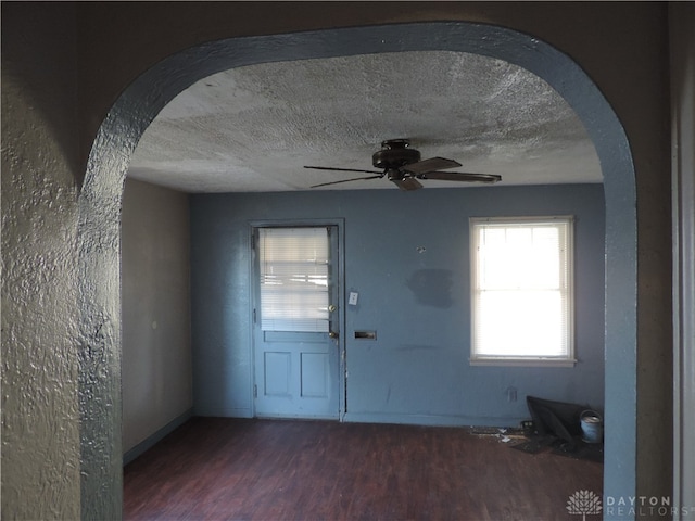 entrance foyer featuring a textured ceiling, dark hardwood / wood-style floors, and ceiling fan