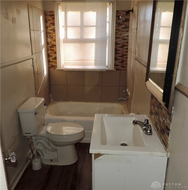 full bathroom with wood-type flooring, vanity, bathing tub / shower combination, and toilet