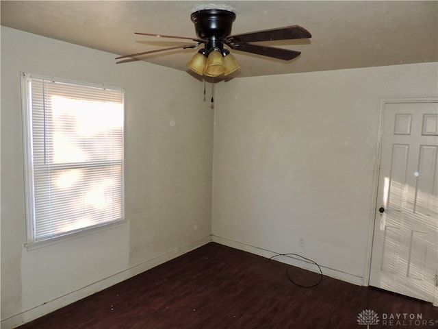 unfurnished room featuring ceiling fan and dark hardwood / wood-style flooring