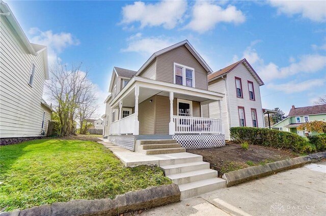 view of front of property with a front yard and a porch