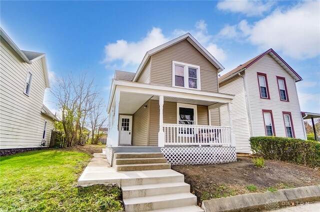 view of front of property with a porch and a front yard