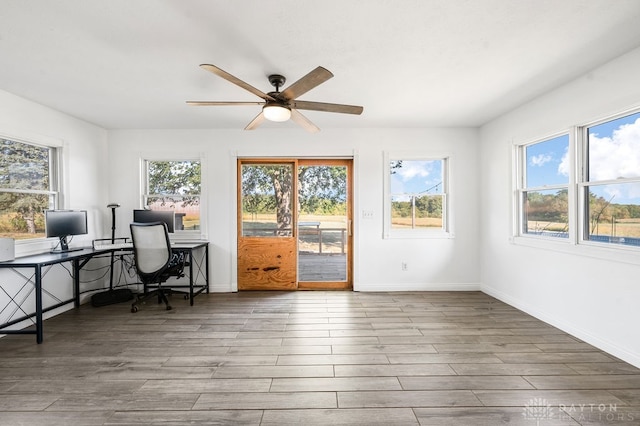 office area featuring a wealth of natural light, hardwood / wood-style floors, and ceiling fan