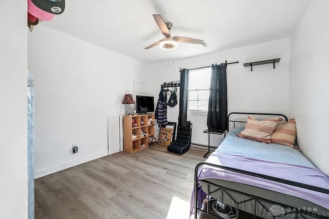 bedroom with light hardwood / wood-style floors and ceiling fan