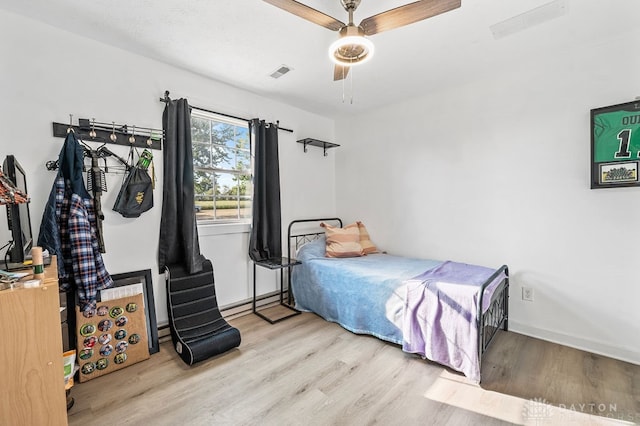 bedroom featuring light wood-type flooring and ceiling fan