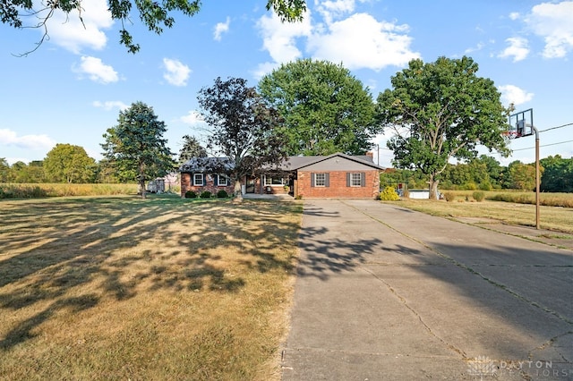 ranch-style home featuring a front yard