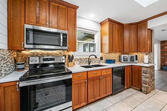 kitchen with light tile patterned floors, stainless steel appliances, tasteful backsplash, and sink