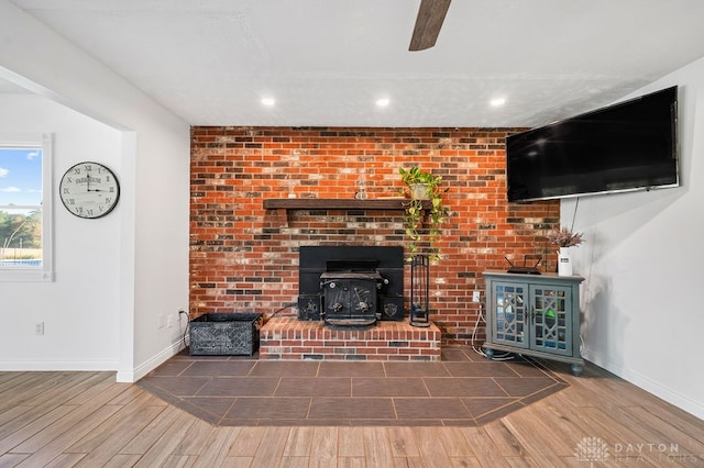 unfurnished living room featuring hardwood / wood-style flooring and a wood stove