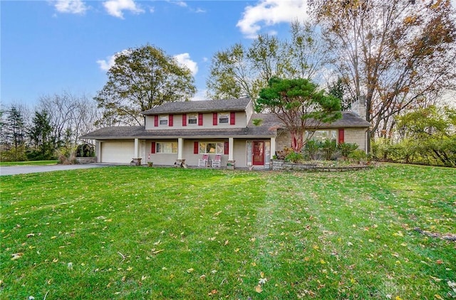 view of front facade with a front yard, a garage, and covered porch