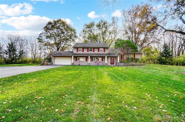 view of front of home featuring a front lawn and a garage