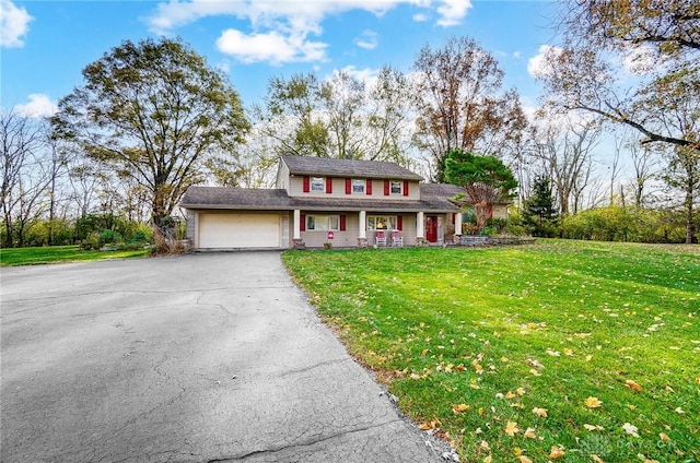 view of front of home with a front lawn and a garage