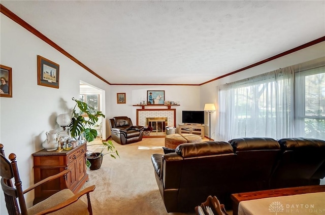 carpeted living room with crown molding, a fireplace, a healthy amount of sunlight, and a textured ceiling