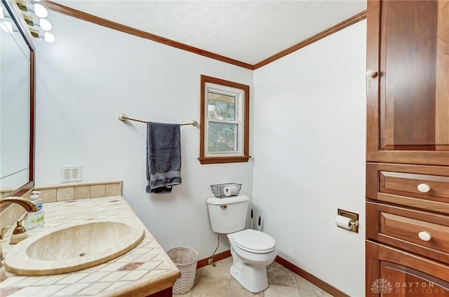 bathroom with toilet, vanity, tile patterned floors, and crown molding