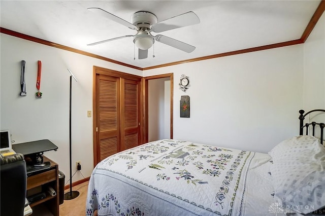 carpeted bedroom with a closet, ceiling fan, and crown molding