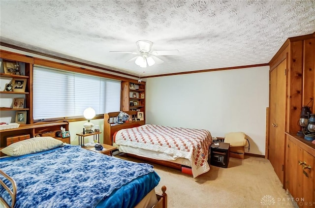 carpeted bedroom featuring ceiling fan, a textured ceiling, and ornamental molding