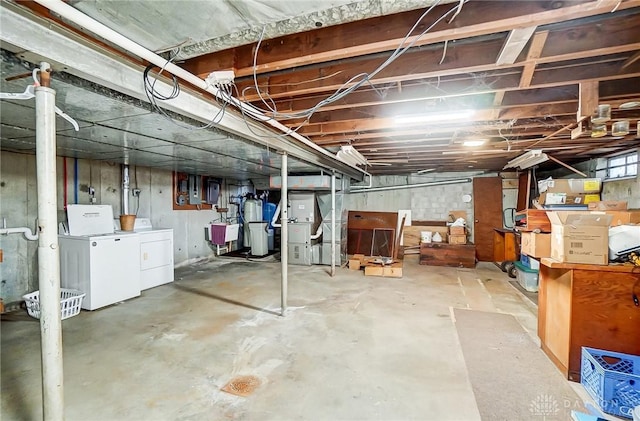 basement featuring washing machine and dryer and sink