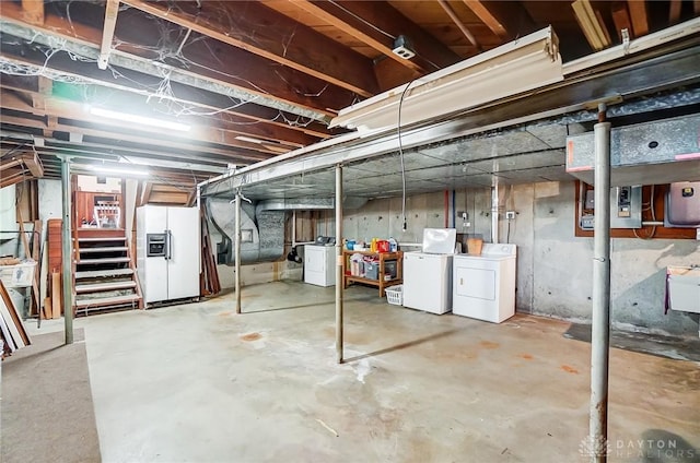 basement with washer and dryer and white refrigerator with ice dispenser