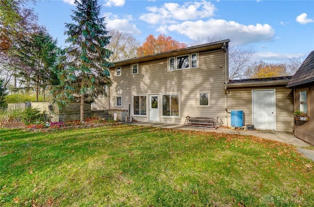 back of property featuring a yard and a patio