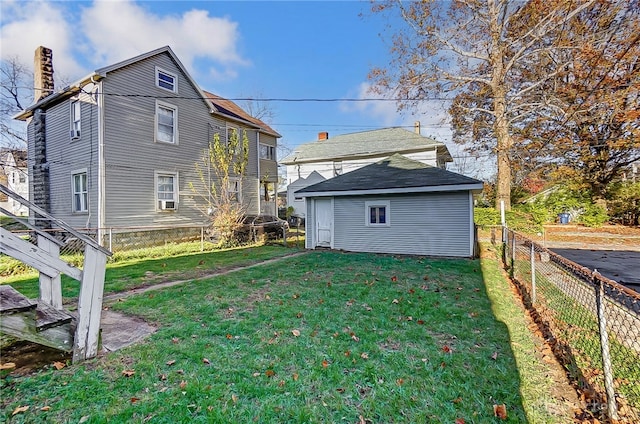 rear view of house with a yard