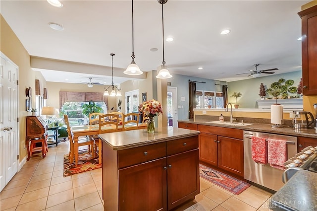 kitchen featuring a center island, sink, stainless steel dishwasher, light tile patterned floors, and decorative light fixtures