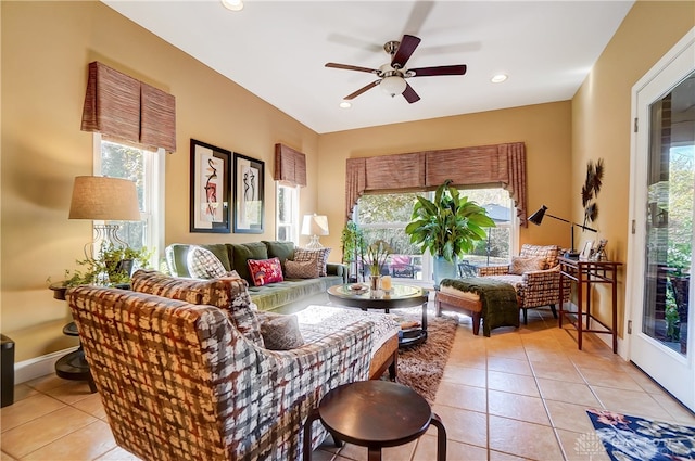 living room with light tile patterned floors, plenty of natural light, and ceiling fan