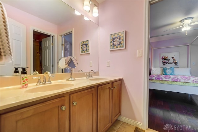 bathroom with hardwood / wood-style floors, ceiling fan, and vanity