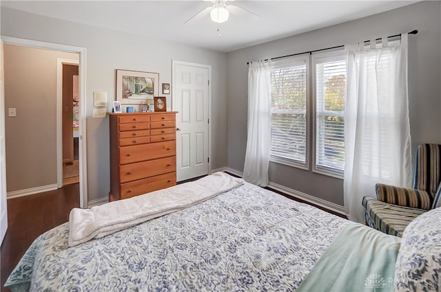 bedroom with ceiling fan and dark wood-type flooring