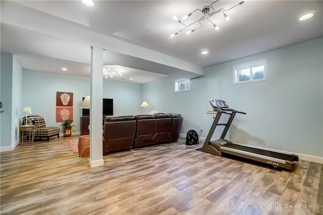 exercise room with light hardwood / wood-style flooring