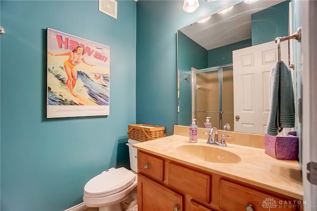 bathroom featuring vanity, toilet, and walk in shower