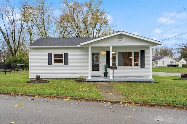 view of front of property with a porch and a front yard