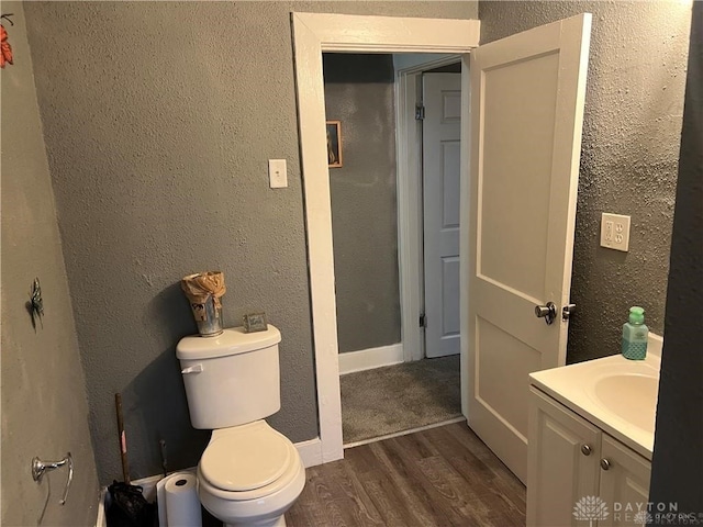 bathroom featuring hardwood / wood-style floors, vanity, and toilet