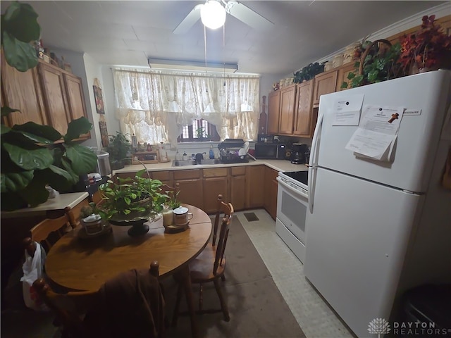 kitchen featuring ceiling fan, sink, and white appliances