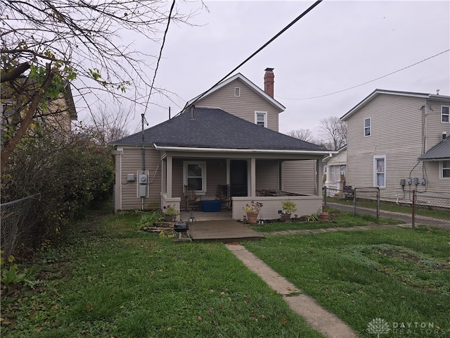 back of house featuring a patio area and a yard