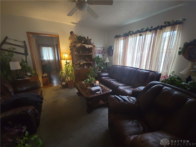 living room with carpet, ceiling fan, and a healthy amount of sunlight