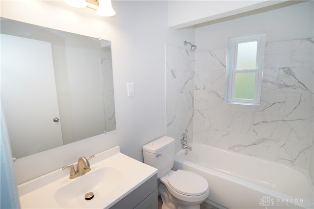 full bathroom with vanity, tiled shower / bath combo, and toilet