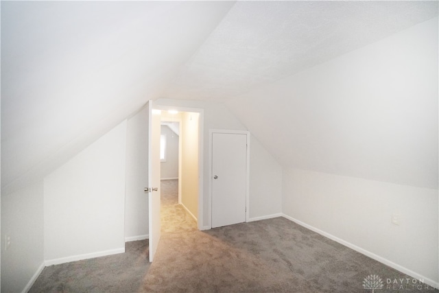 bonus room featuring carpet and vaulted ceiling