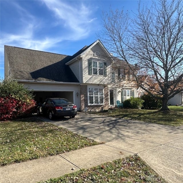 view of front of property featuring a front yard and a garage