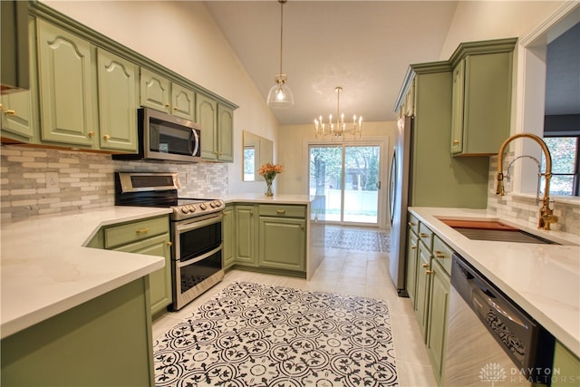 kitchen with green cabinetry, sink, stainless steel appliances, and vaulted ceiling