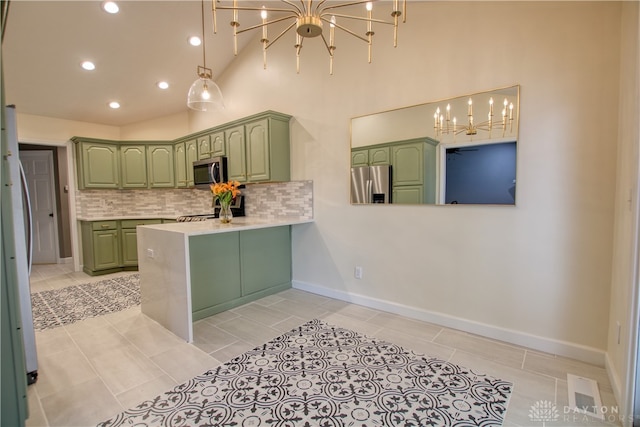 kitchen featuring backsplash, green cabinets, kitchen peninsula, and stainless steel appliances