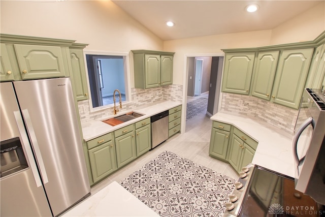 kitchen featuring green cabinets, sink, lofted ceiling, and stainless steel appliances