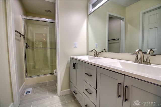 bathroom with vanity, toilet, and an enclosed shower